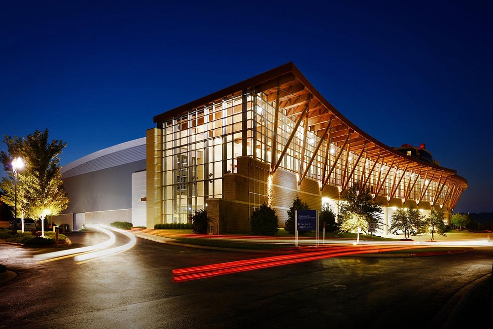 The Branson Convention Center at night, its glass front lit from within